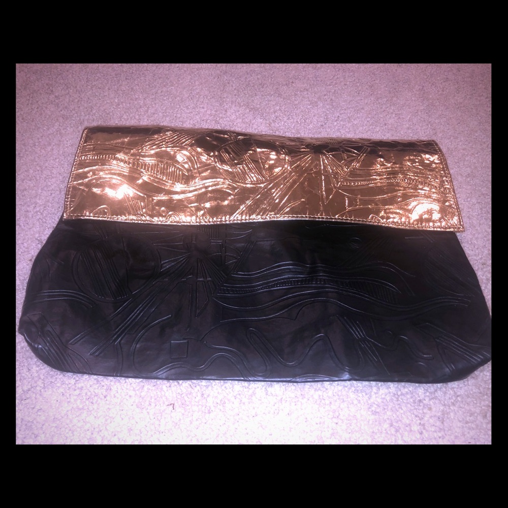 Oversized black and gold clutch
